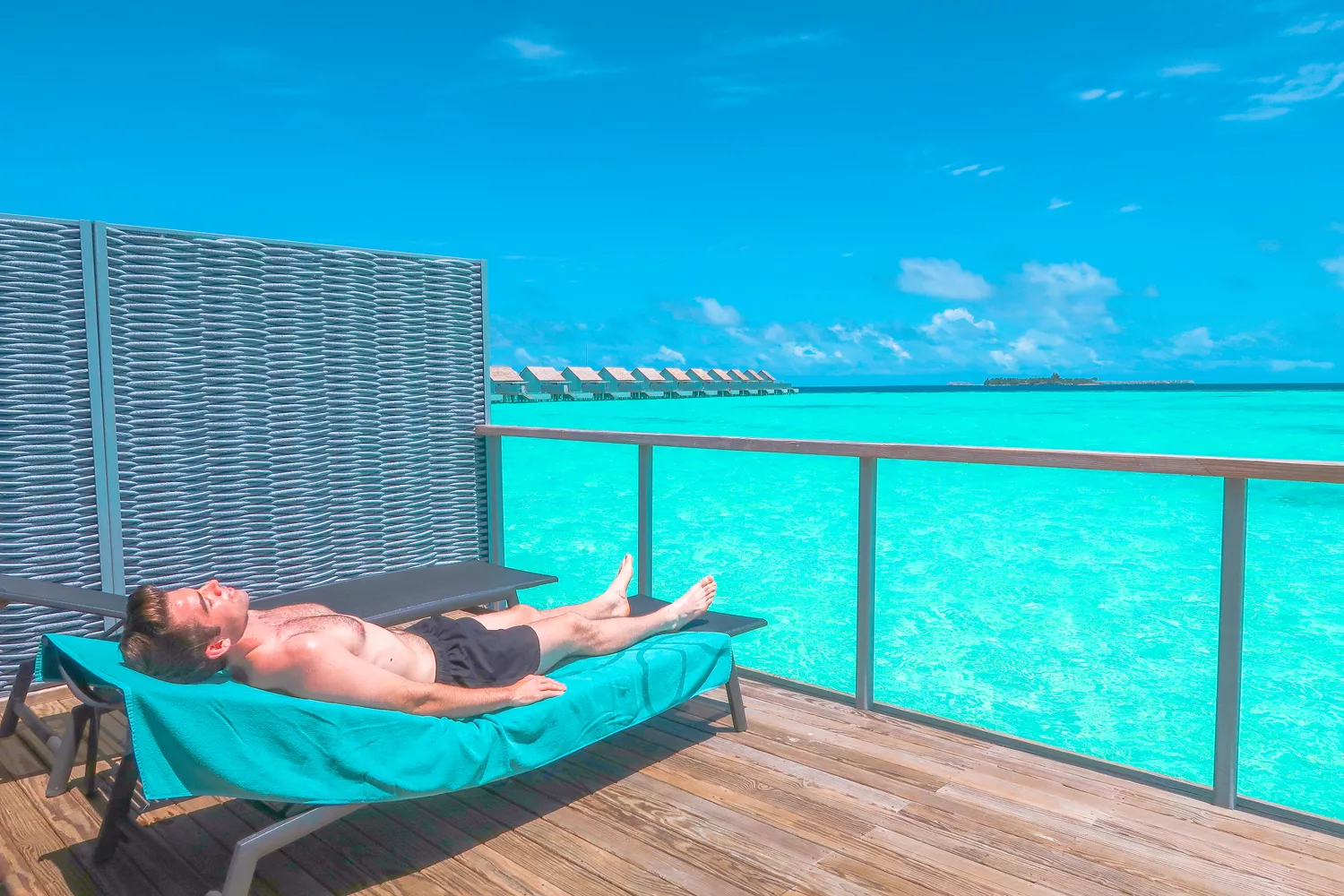 Overwater villa in the Maldives at sunset showing turquoise lagoon